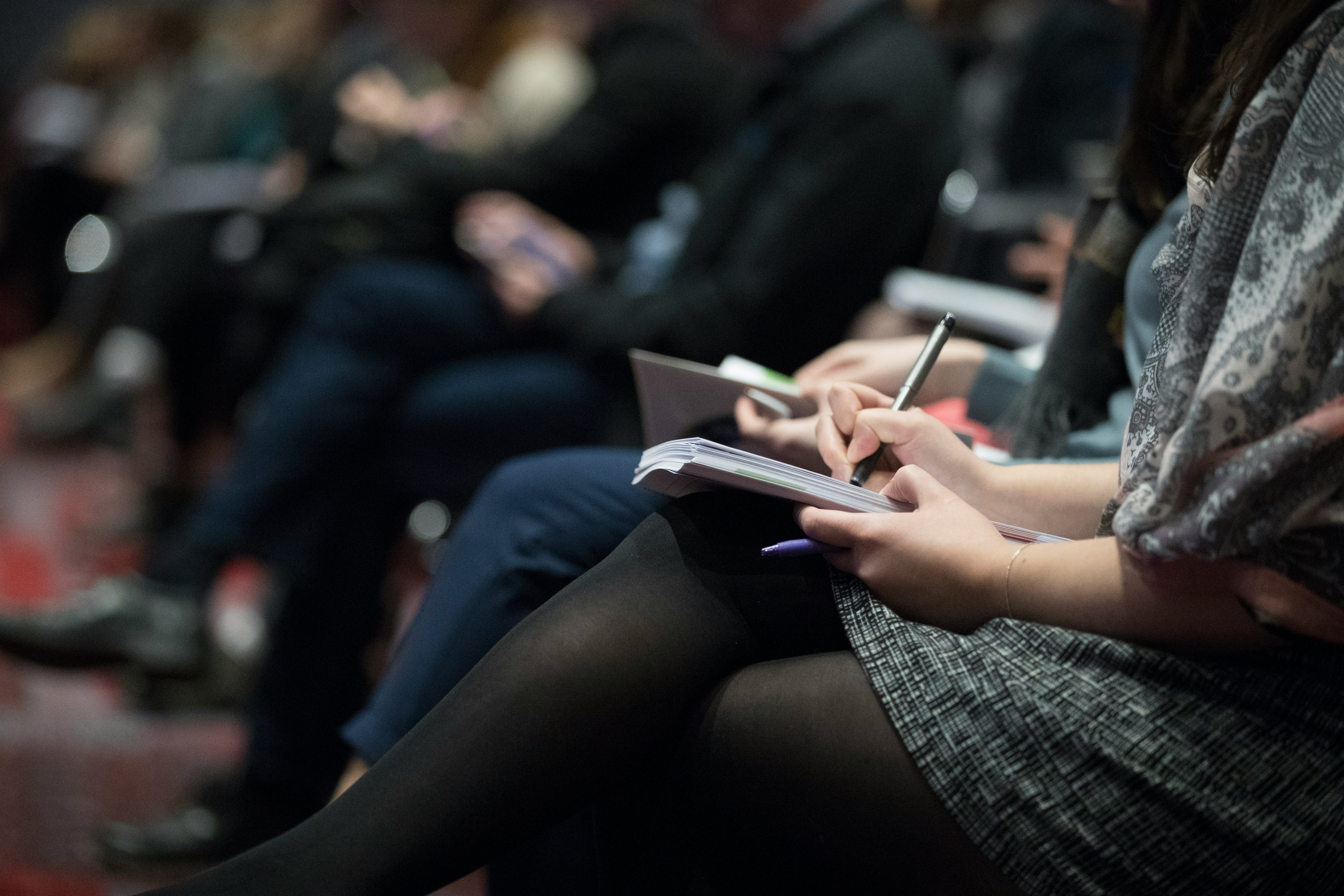 A group of people taking notes during a teaching event
