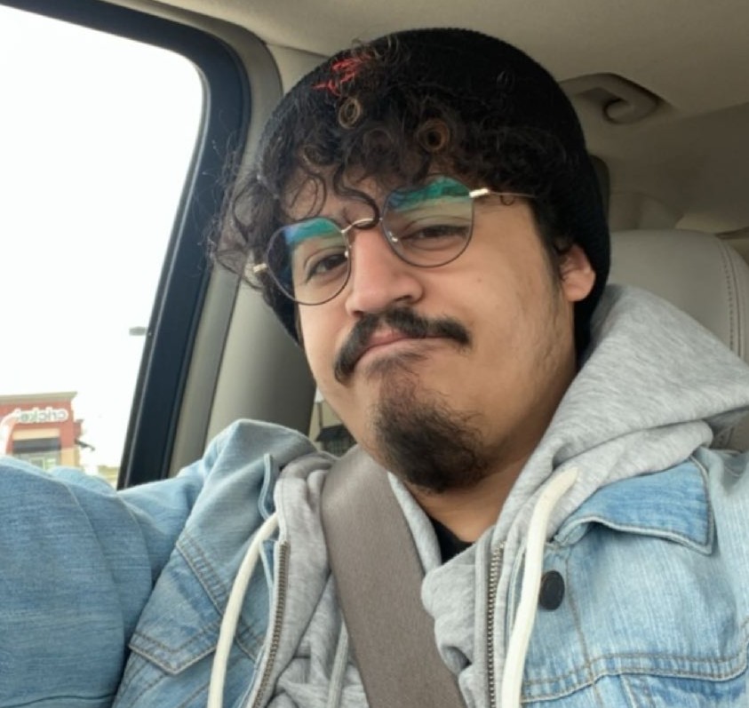 A front face selfie photo of Jose Figueroa in his car